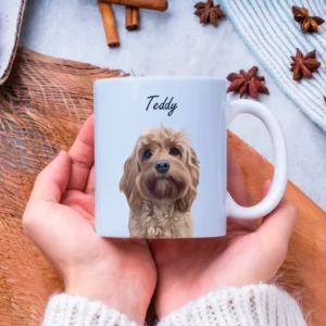 Woman holding an 11oz light blue mug with a custom dog portrait and name