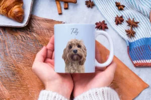 Woman holding an 11oz light blue mug with a custom dog portrait and name